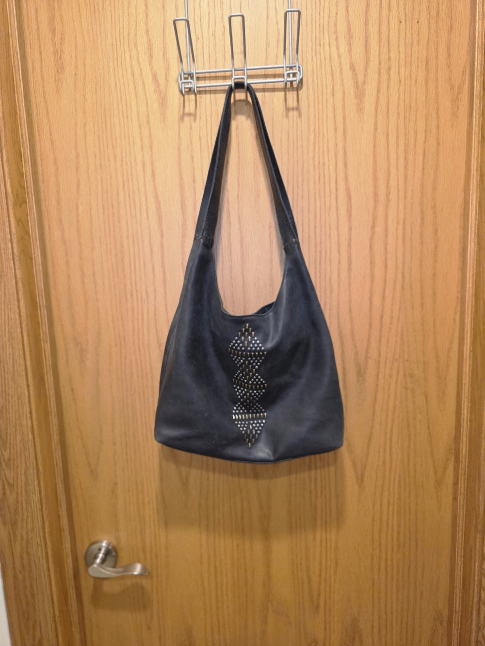 The Sak Black Leather Shoulder Bag with Studded Geometric Accent